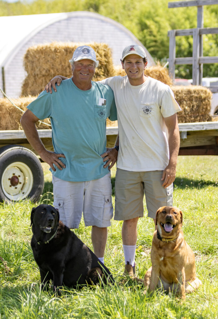 Tom Larrabee Jr. and his son Nick with their dogs at My Grandfather's Farm